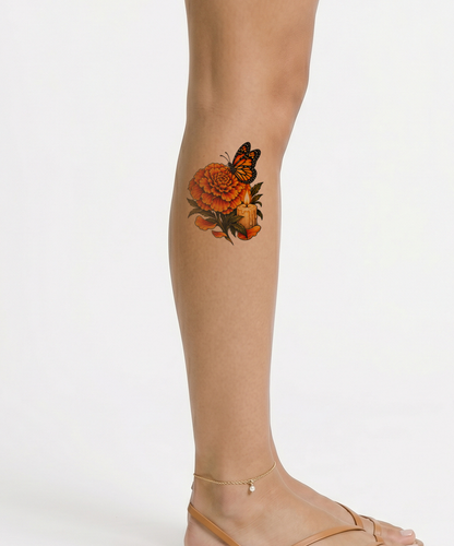 Gedenktattoo mit Ringelblume, Monarchfalter und Kerze